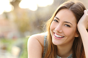 Woman with tooth colored fillings smiling outside