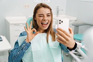 Dental patient taking selfie with her new veneers