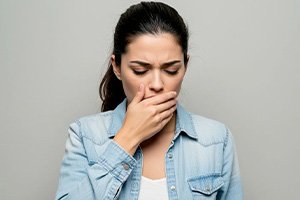Concerned woman covering her mouth