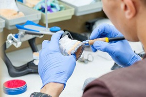 Dental lab technician working on dentures