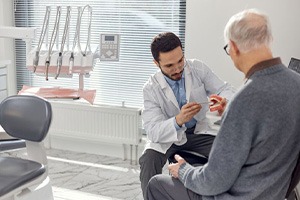 Dentist talking with senior patient