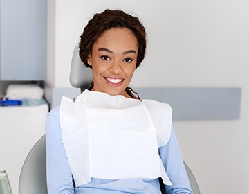 Woman smiling in dental exam chair