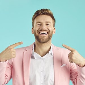 Smiling, handsome man pointing at himself