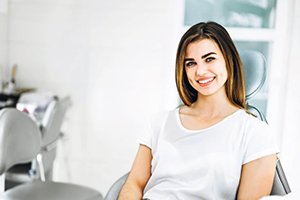 Female dental patient smiling in treatment chair