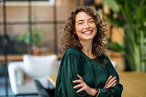 Happy, smiling woman wearing green blouse