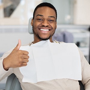 Happy dental patient making thumbs-up gesture