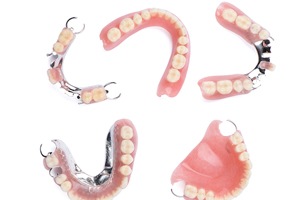 Partial and full dentures against plain white background