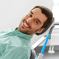 Man smiling after treatment for toothache