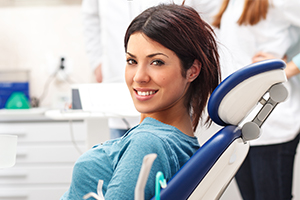 Woman smiling at camera after tooth extractions