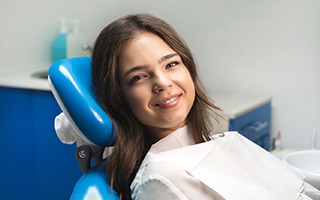Satisfied dental patient sitting in treatment chair