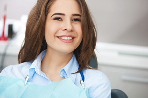 Female patient smiling after successful dental implant treatment