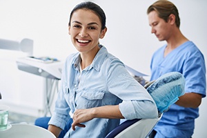 Happy patient at appointment to receive tooth-colored fillings