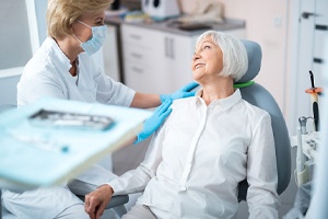 Dentist and patient discussing need for full mouth reconstruction