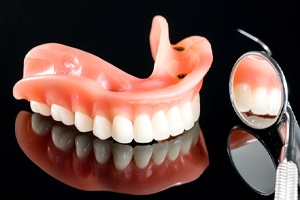 Implant denture on reflective surface, next to mirror