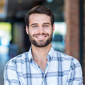 Man smiling after dental implant tooth replacement