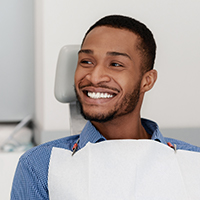 Man smiling after replacing multiple missing teeth