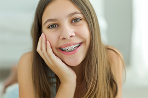 Teen girl with traditional braces smiling