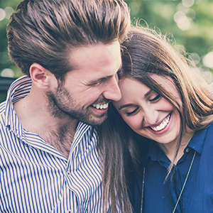 Man and woman laughing after preventive dentistry visit