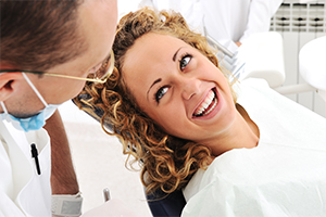 Woman smiling at dentist during dental checkup