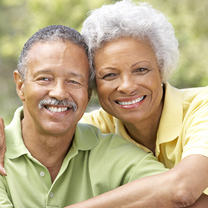 Man and woman smiling after restorative dentistry