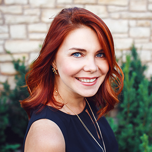 Red haired woman smiling after root canal therapy