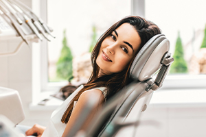 Woman laying back in exam chair after root canal therapy