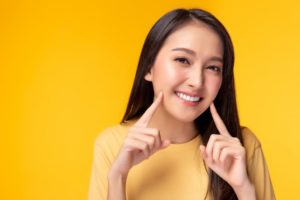 Woman with bright smile after whitening bonded teeth