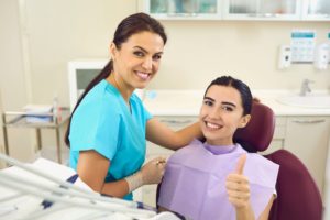 Dental patient with straight teeth giving thumbs up for life after braces in Needham