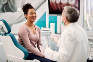 a person talking to their dentist during a checkup and cleaning