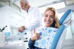 Happy dental patient giving thumbs up for root canal therapy in Needham