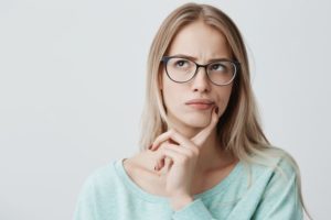 Puzzled woman, curious about the need for a root canal in Needham