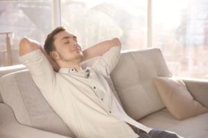Man resting on sofa after dental appointment