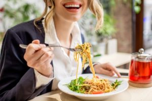 Professional woman enjoying pasta for lunch