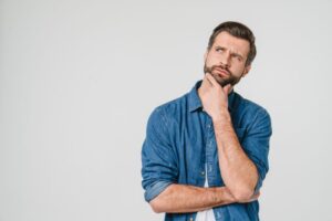 Man wearing thoughtful, curious expression 