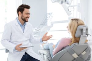 Dentist answering patient&rsquo;s questions during consultation 